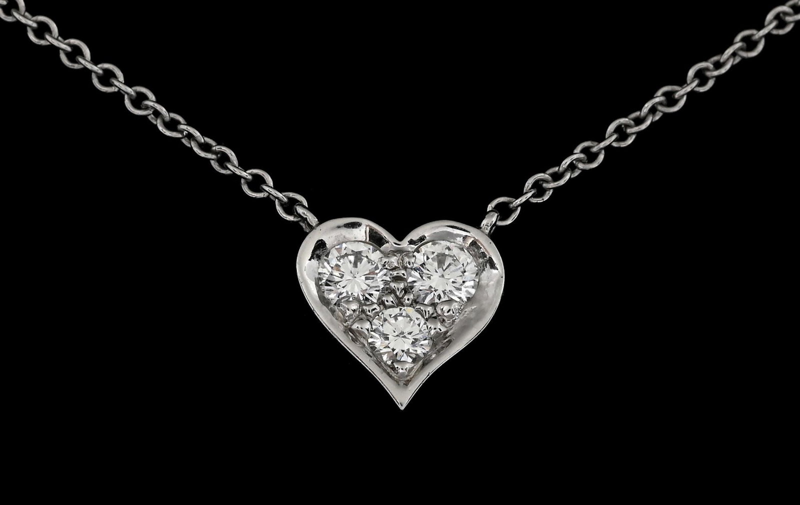 TIFFANY & CO PLATINUM & DIAMOND HEART NECKALCE: Platinum Tiffany & Co diamond heart necklace consisting of 3 round brilliant cut natural diamonds with a total weight of 0.20cts. Length measures 16". Width of heart measures 7.5mm. Gross weight is 11