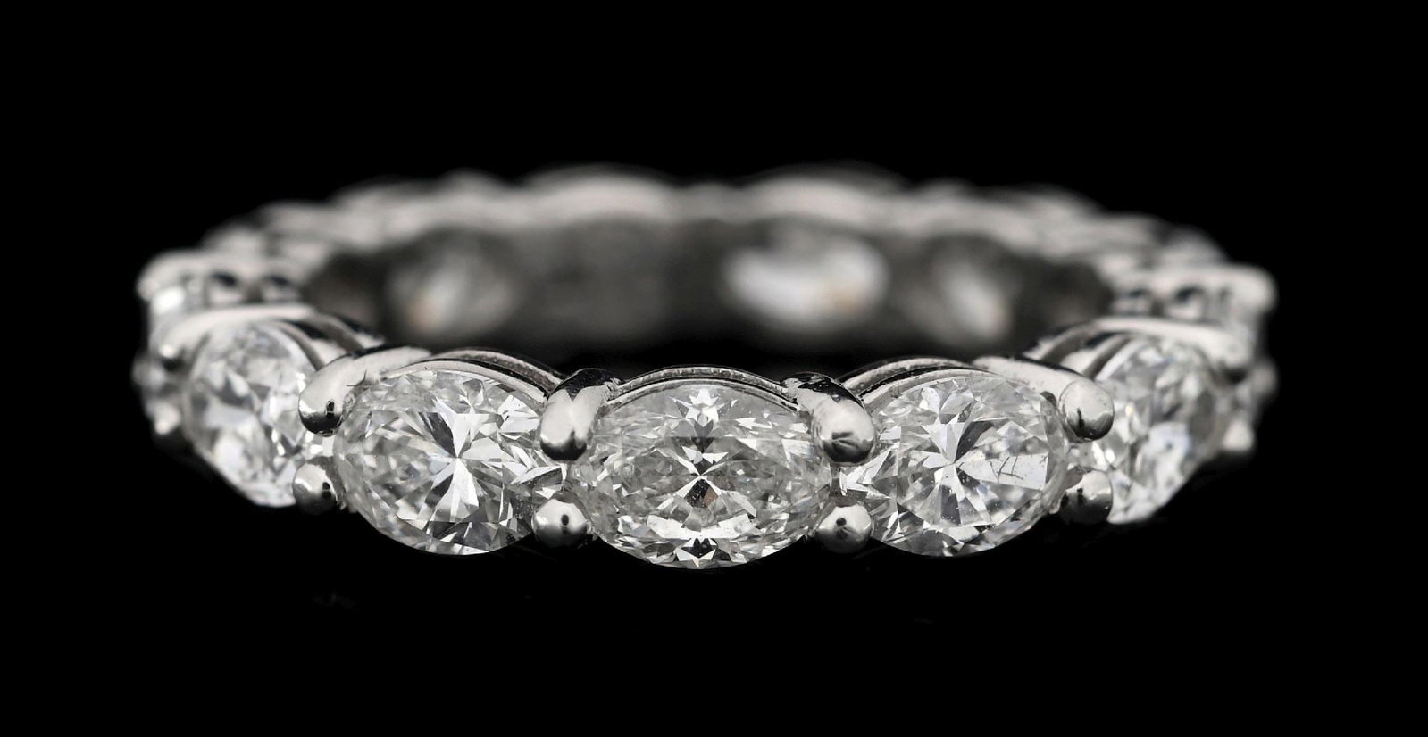 PLATINUM OVAL DIAMOND ETERNITY BAND, 4.01CT TW: Platinum diamond eternity band consisting of 13 oval brilliant cut near-colorless natural diamonds with a total weight of 4.01cts. Width measures 4mm. Finger size 6-1/4. Gross weight is 5.0 grams. Mar