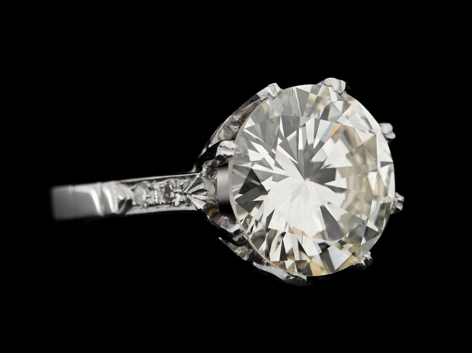 PLATINUM 5.88CT YELLOW DIAMOND RING W/GIA REPORT (O/P COLOR): Platinum natural yellow diamond estate ring consisting of 1 round brilliant cut natural diamond weighing 5.88cts, graded O/P color, VS1 clarity, and 4 round single cut near-colorless natural diamonds 