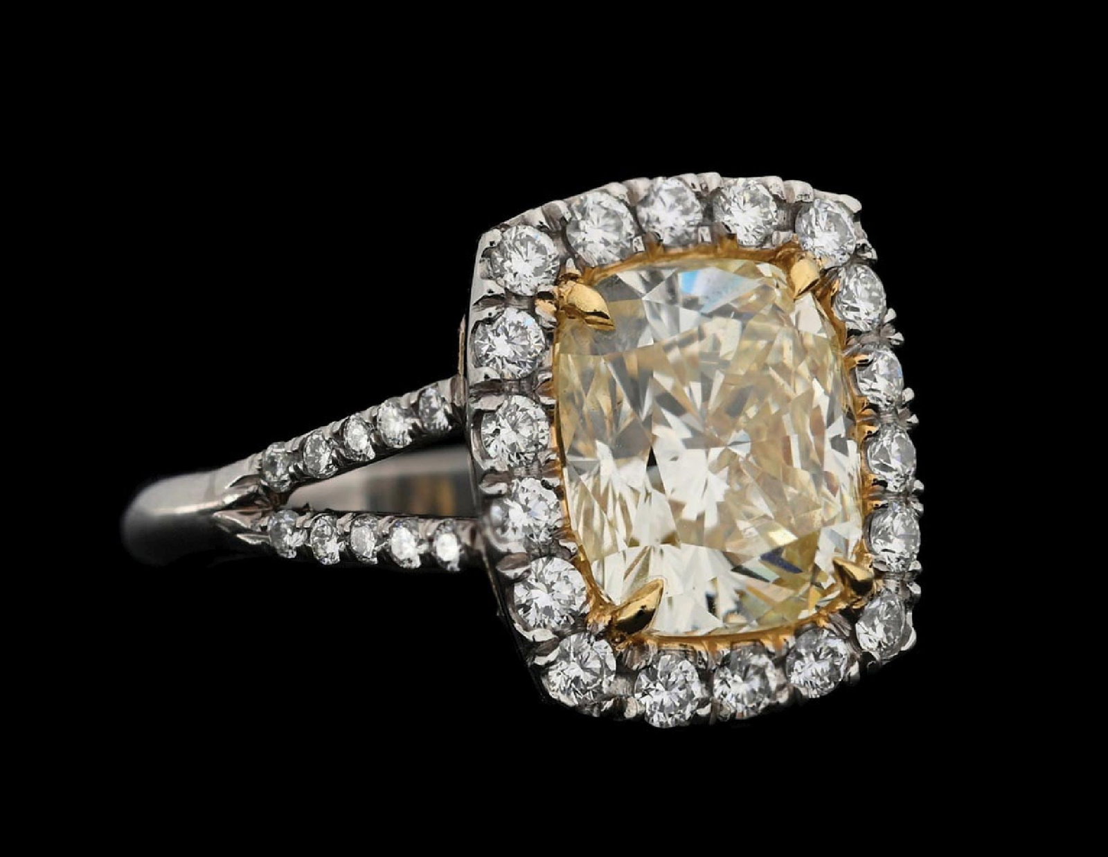PLATINUM 4.36CT YELLOW DIAMOND RING W/GIA REPORT (Y/Z COLOR): Platinum natural yellow diamond ring consisting of 1 cushion cut natural diamond weighing 4.36cts, graded Y/Z color, VS1 clarity, and 38 round brilliant cut near-colorless natural diamonds with a tota