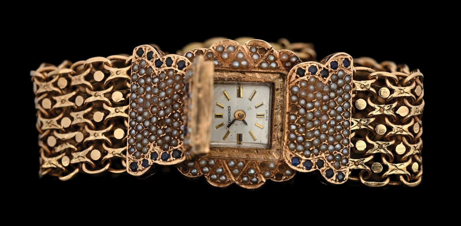 14K YELLOW GOLD SECRET WATCH BRACELET W/DIAMONDS, SAPPHIRES, SEED PEARLS & ENAMEL: Stunning 14k yellow gold bracelet with secret Longines watch, adorned with diamonds, sapphires and seed pearls with blue enameled flowers and monogram. Length measures 7-1/4" clasped. Width at center 