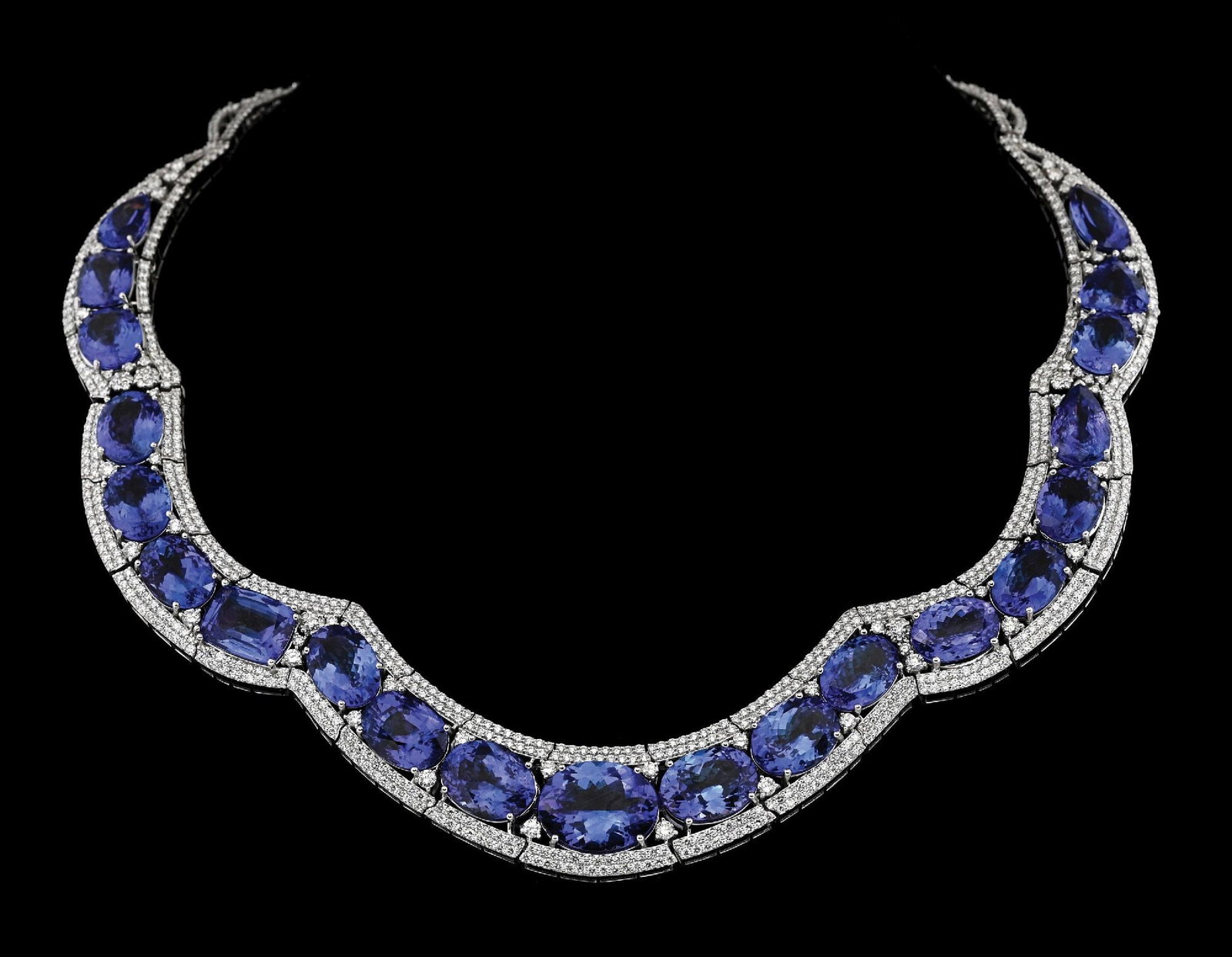14K WHITE GOLD 121.44CT TW TANZANITE & DIAMOND NECKLACE W/REPORT: 14k white gold tanzanite (121.44ctw) and diamond (16.70ctw) statement necklace accompanied by an original GGA appraisal report with an ERRV of $381,290.00. (See additional website images for report sp