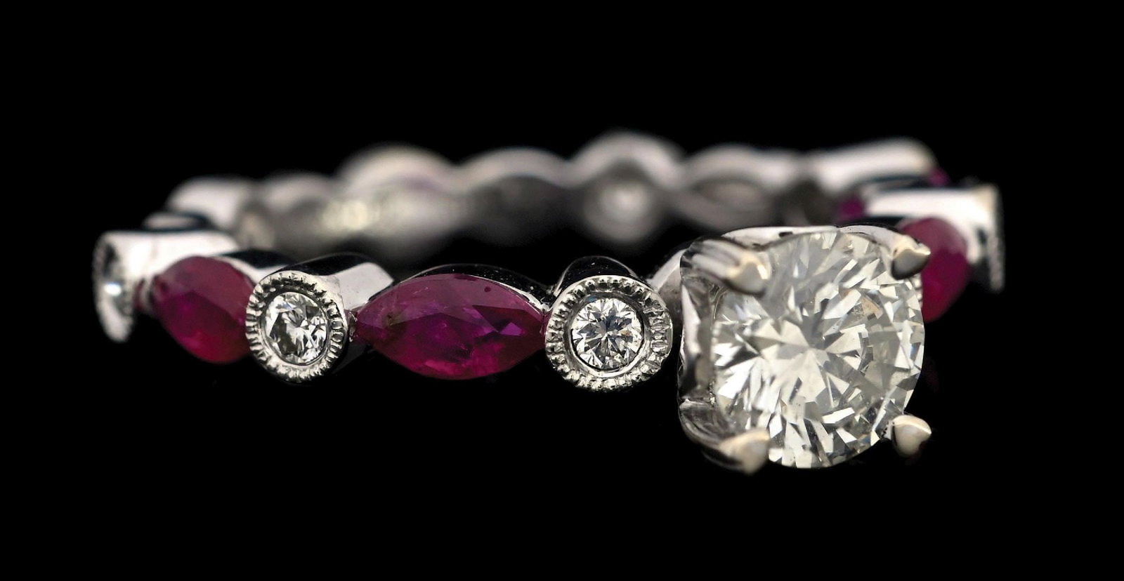 18K WHITE GOLD DIAMOND & RUBY RING W/ REPORT: 18k white gold diamond (0.70ct center, 0.16ctw sides) and ruby (0.63ctw) engagement ring accompanied by an original GGA appraisal report with an ERRV of $12,540.00. (See additional website images for 