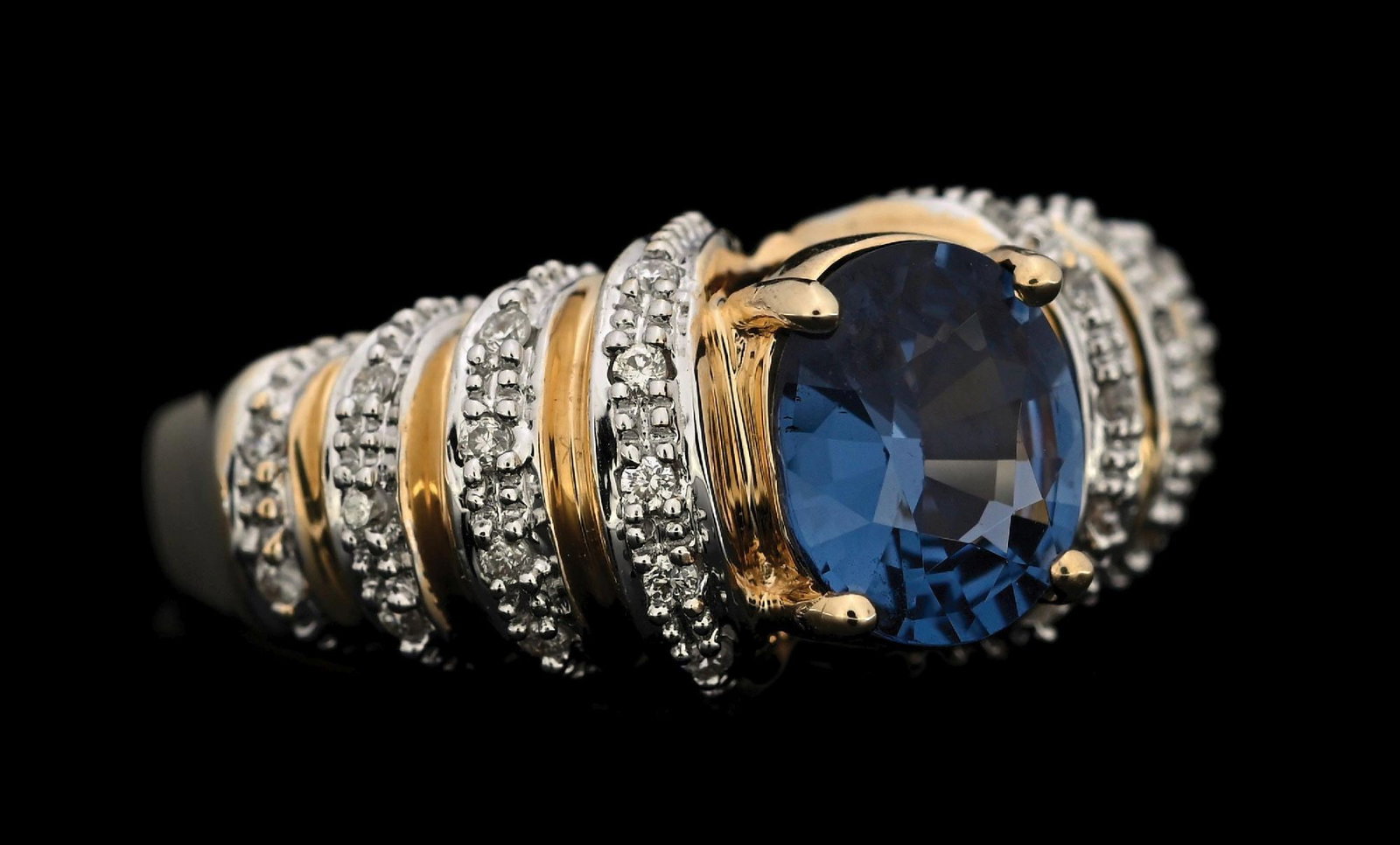 14K YELLOW GOLD BLUE SPINEL & DIAMOND RING W/REPORT: 14k yellow gold blue spinel (1.77ct) and diamond (0.15ctw) ring accompanied by an original GGA appraisal report with an ERRV of $14,370.00. (See additional website images for report specifications). R