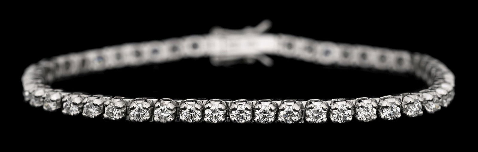 18K WHITE GOLD 4CT TW DIAMOND TENNIS BRACELET: 18k white gold diamond line/tennis bracelet consisting of 47 round brilliant cut near-colorless natural diamonds with a total weight of 4.00cts. Length measures 7". Width measures 3.25mm. Gross weight