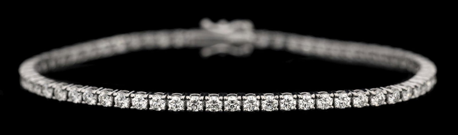 14K WHITE GOLD DIAMOND LINE BRACELET, 3.25CT TW: 14k white gold diamond line/tennis bracelet consisting of 64 round brilliant cut near-colorless natural diamonds with a total weight of 3.25cts. Length measures 7". Width measures 2.5mm. Gross weight 