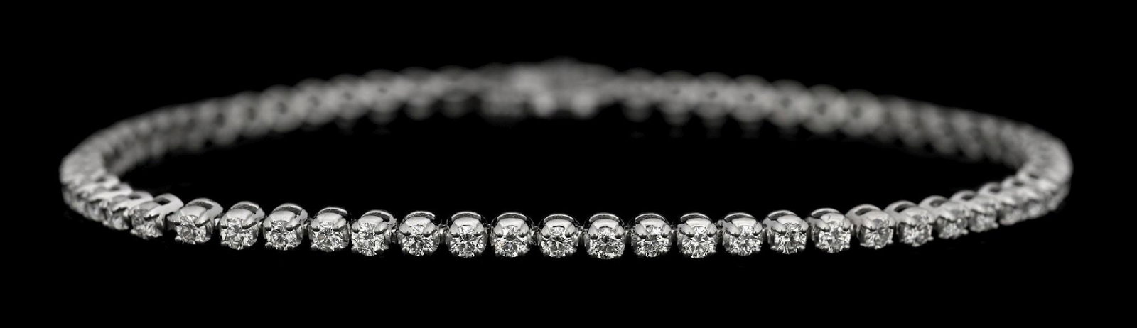 PLATINUM 2CT TW DIAMOND TENNIS BRACELET: Platinum and diamond line/tennis bracelet consisting of 64 round brilliant cut near-colorless natural diamonds with an estimated total weight of 2.00cts. Length measures 7-1/4". Width measures 3mm. Gr