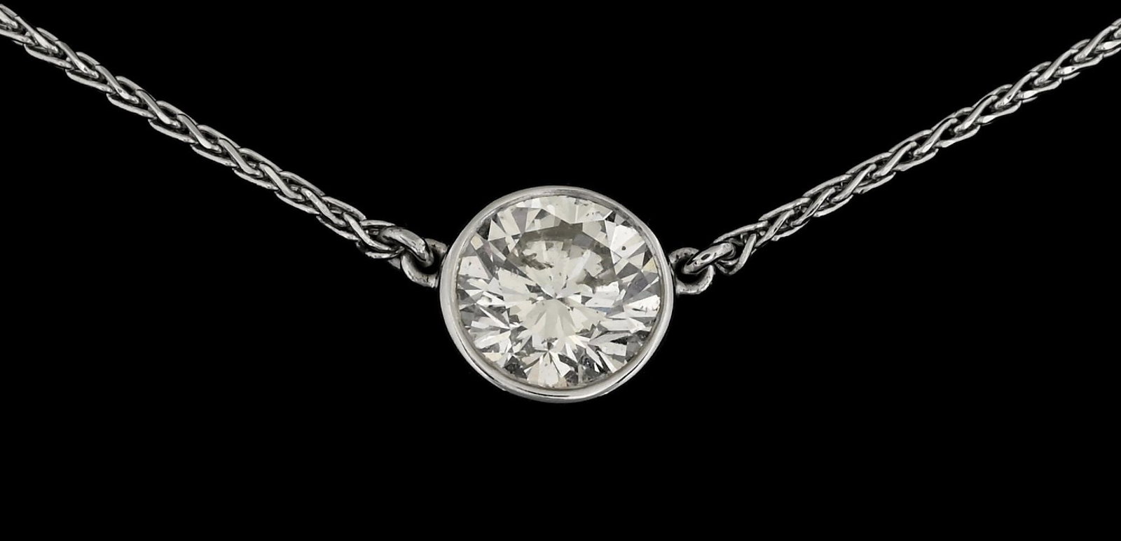 14K WHITE GOLD BEZEL-SET 1.45CT DIAMOND NECKLACE: 14k white gold bezel-set diamond necklace consisting of 1 round brilliant cut natural diamond weighing 1.45cts. Length measures 17". Bezel width measures 8mm. Gross weight is 3.5 grams. Marked "14K". 