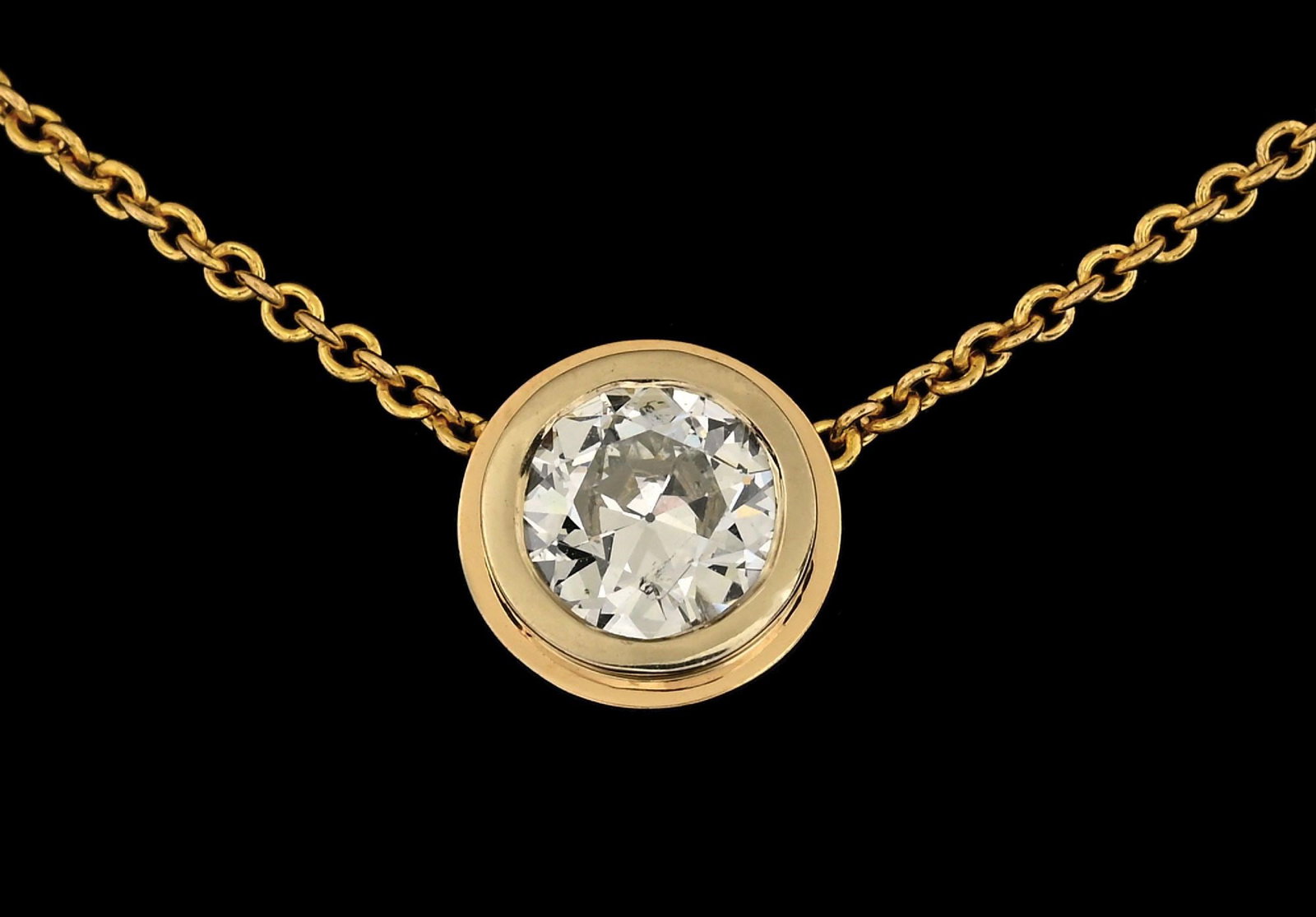 14K YELLOW GOLD BEZEL-SET 0.80CT DIAMOND NECKLACE: 14k yellow gold bezel-set diamond necklace consisting of 1 round brilliant cut natural diamond weighing 0.80cts. Length measures 18". Bezel width measures 8mm. Gross weight is 3.6 grams. Marked "14K".