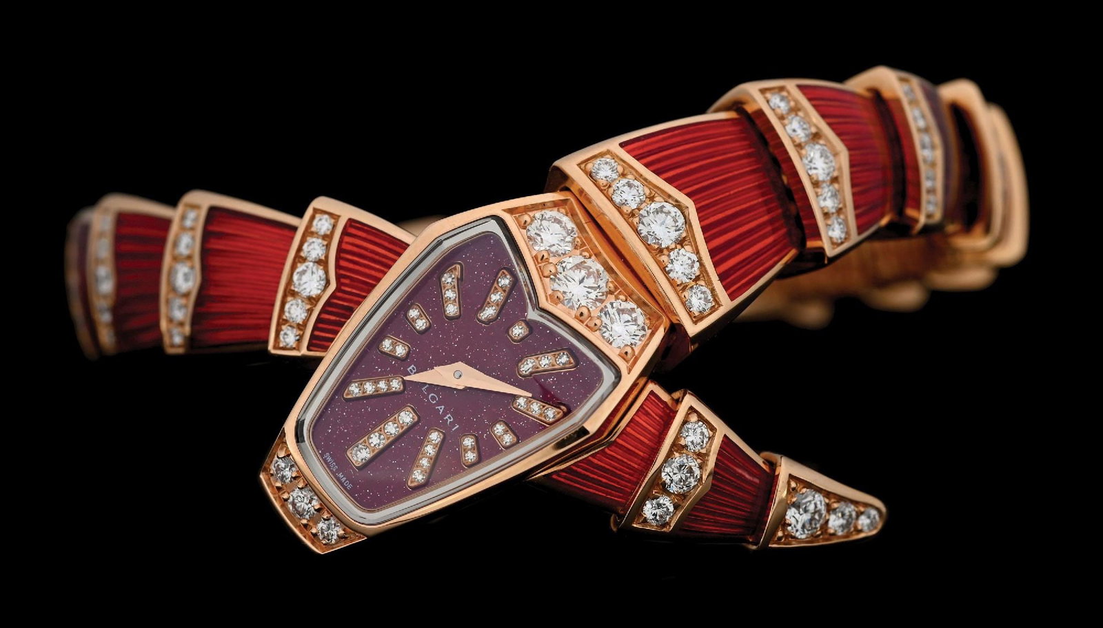 18K ROSE GOLD BVLGARI SERPENTI DIAMOND ENAMELED WATCH W/BOX: 18k rose gold and diamond Bulgari Serpenti Scaglie flexible snake wristwatch finished in translucent red enamel with red lacquered diamond dial. There are a total of 135 round brilliant cut near-color