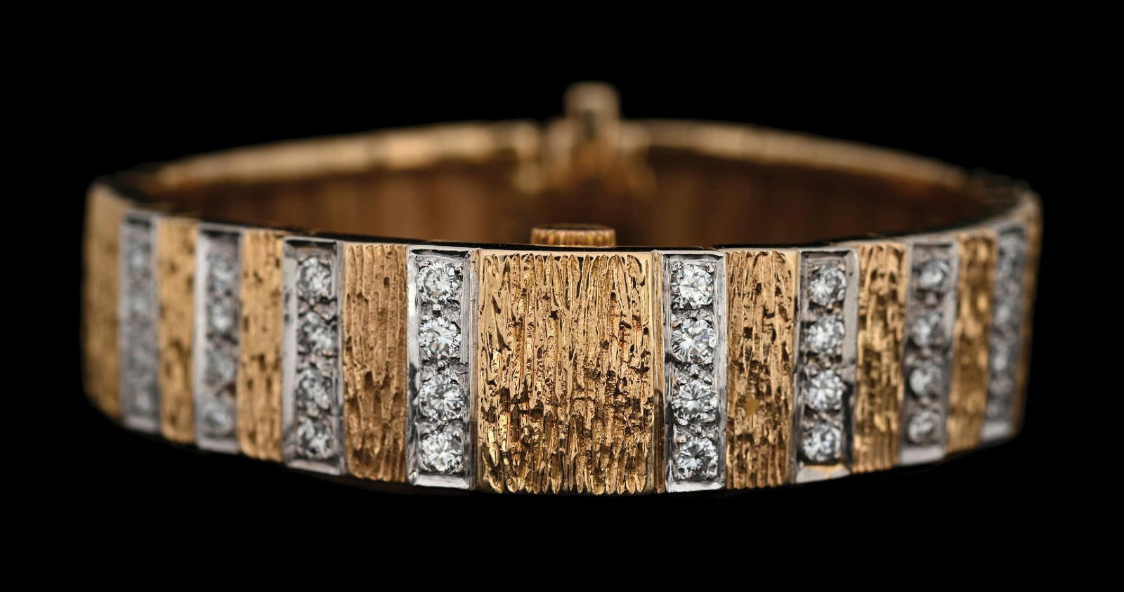 14K T/T GOLD SECRET WATCH BRACELET W/DIAMONDS: 14k yellow and white gold diamond bracelet with secret Otto Grun watch, set with 32 round brilliant cut near-colorless natural diamonds with an estimated total weight of 2.00cts. Length measures just 