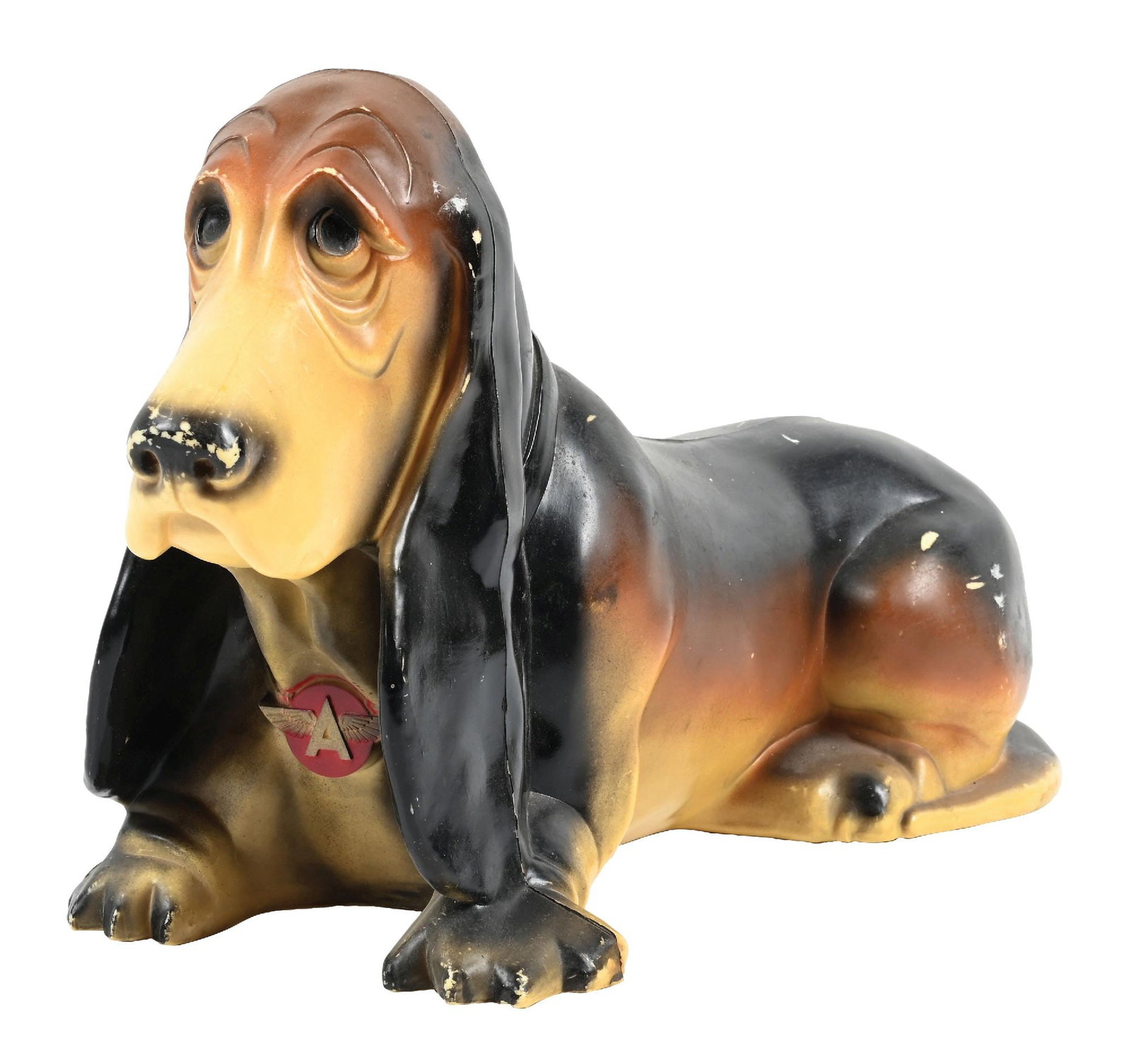 FLYING A BASSET HOUND PIGGY BANK: C. 1950s. CONDITION: Overall very good, showing light general age and use wear. Body showing great original paint with light chips. Flying A graphic in excellent condition. Condition: (ORIGINAL). Dime