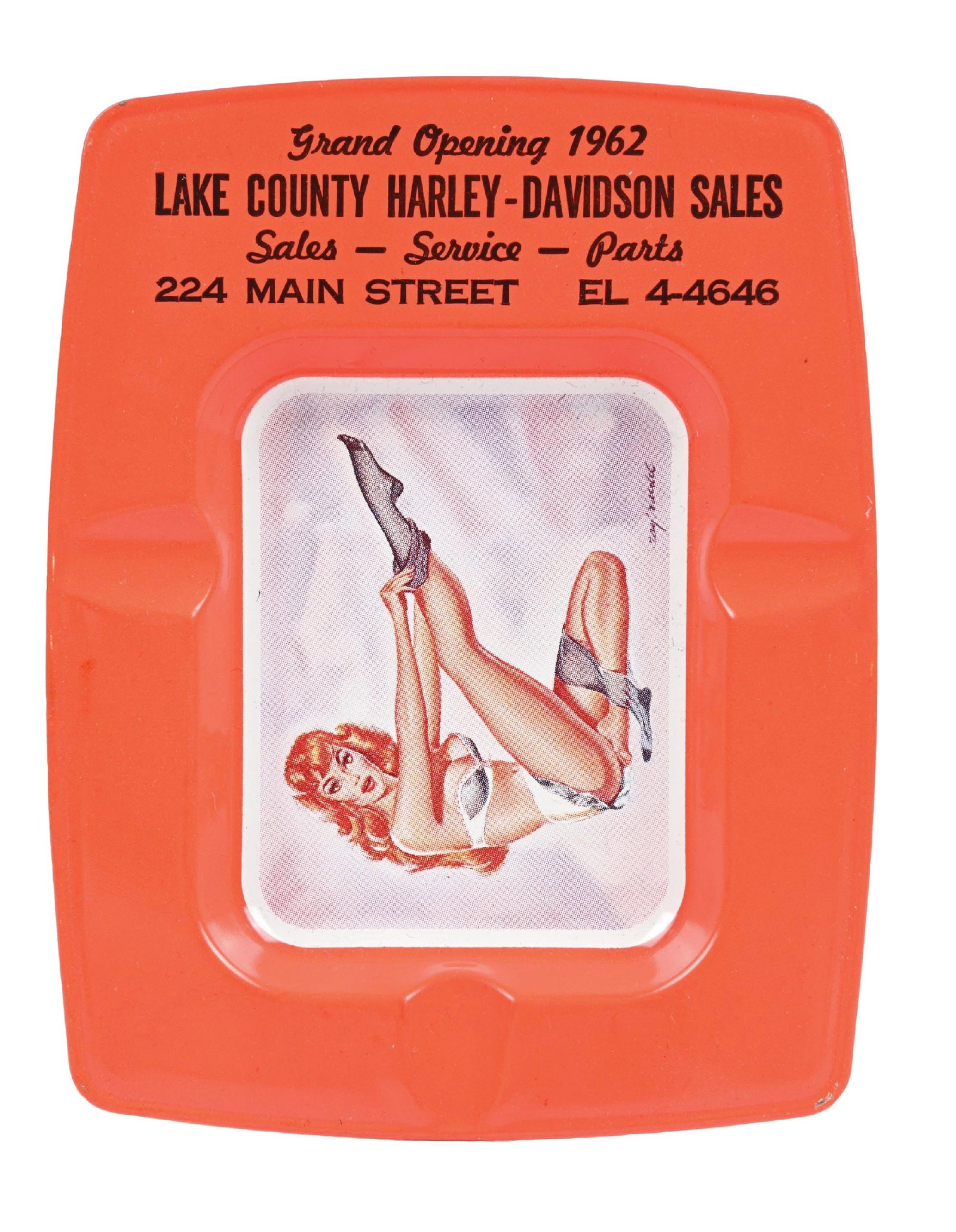LAKE COUNTY HARLEY-DAVIDSON ADVERTISING ASHTRAY: SST. C. 1960s. CONDITION: Outstanding condition throughout appearing n.o.s showing excellent graphic. No notable surface wear with great gloss. Minor paint wear along the edge from storage. A brillian