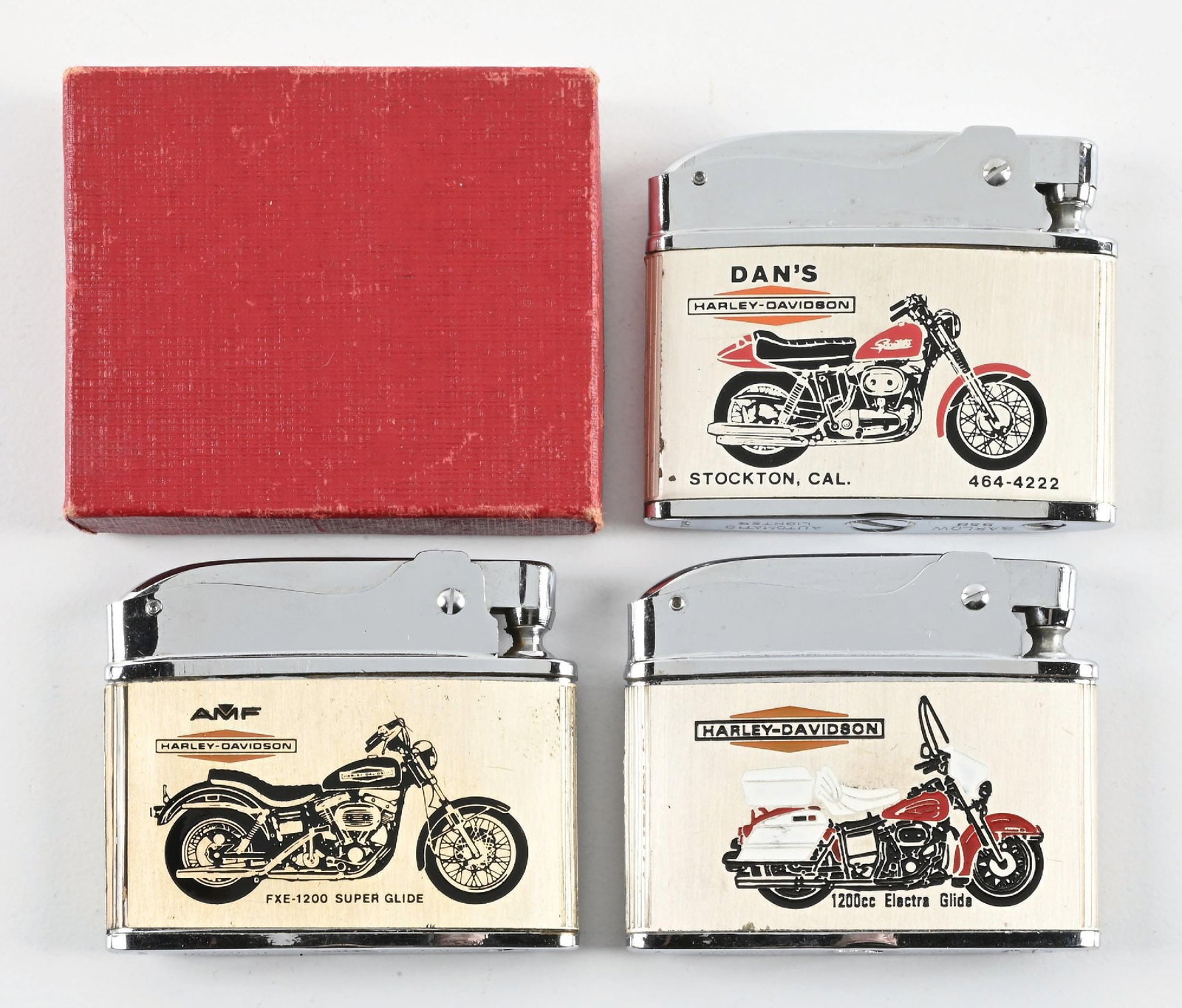 COLLECTION OF 3: HARLEY-DAVIDSON DEALERSHIP LIGHTERS: Collection Consists Of: Three n.o.s. Dealership lighters for Harley Davidson. CONDITION: Each in brilliant condition showing no notable wear, one still in the original box. An excellent condition grou