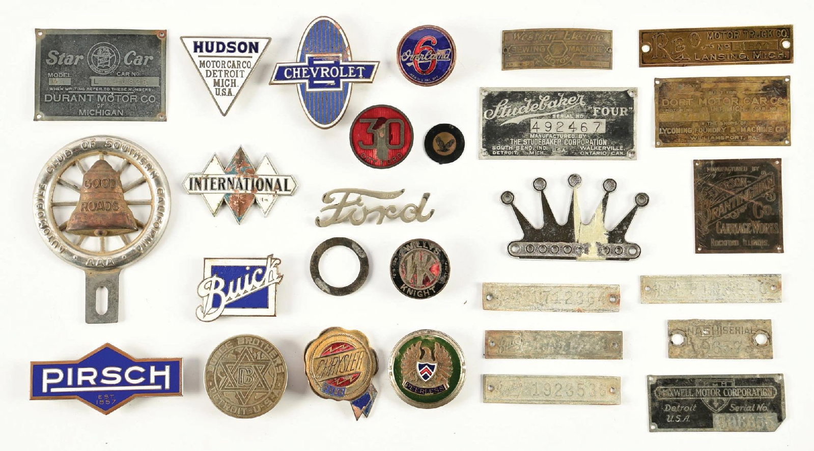 LARGE COLLECTION OF ASSORTED CAR RADIATOR BADGES AND MANUFACTURER PLATES: Collection Consists Of: 27 individual automotive radiator badges as well as manufacturers tags. CONDITION: Each in fair condition showing general age wear. Lot also includes license plate topper for A