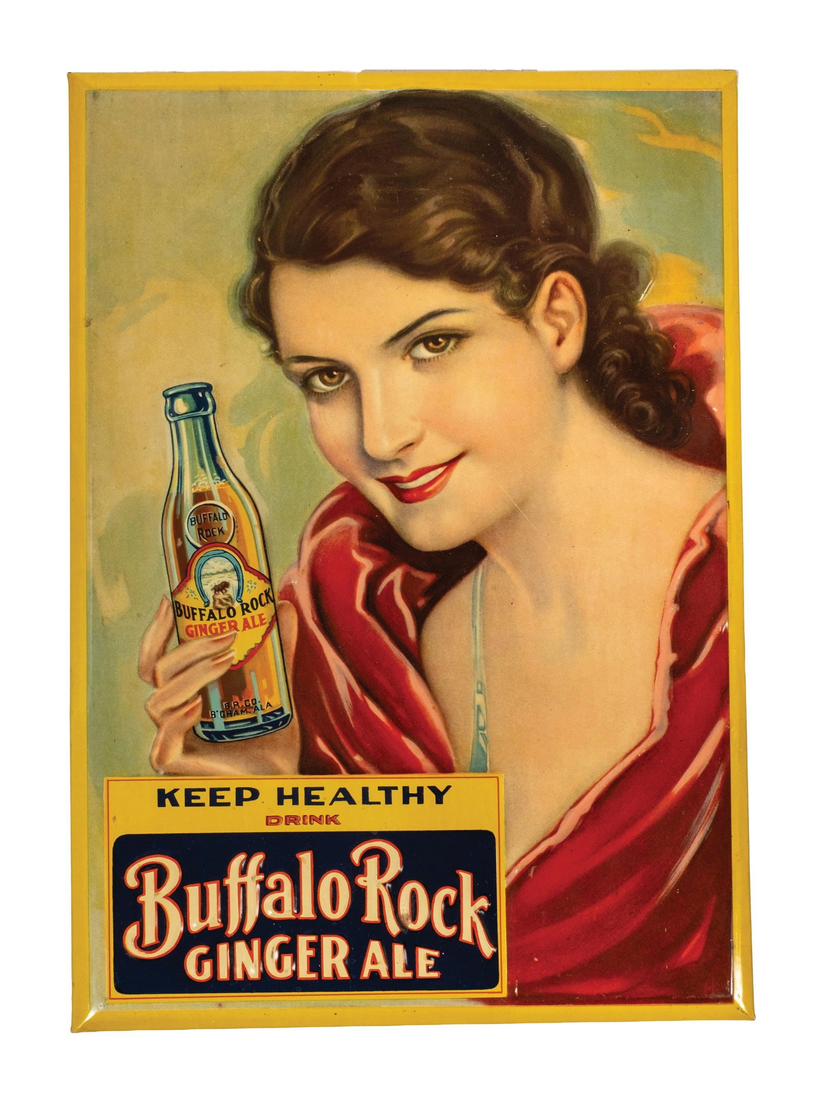BUFFALO ROCKS GINGER ALE ADVERTISING SIGN: Embossed tin over cardboard easel-back Buffalo Rock Ginger Ale with a beautiful young woman in a deep red dress holding the product with the image of the iconic buffalo on the bottle. CONDITION: Beaut