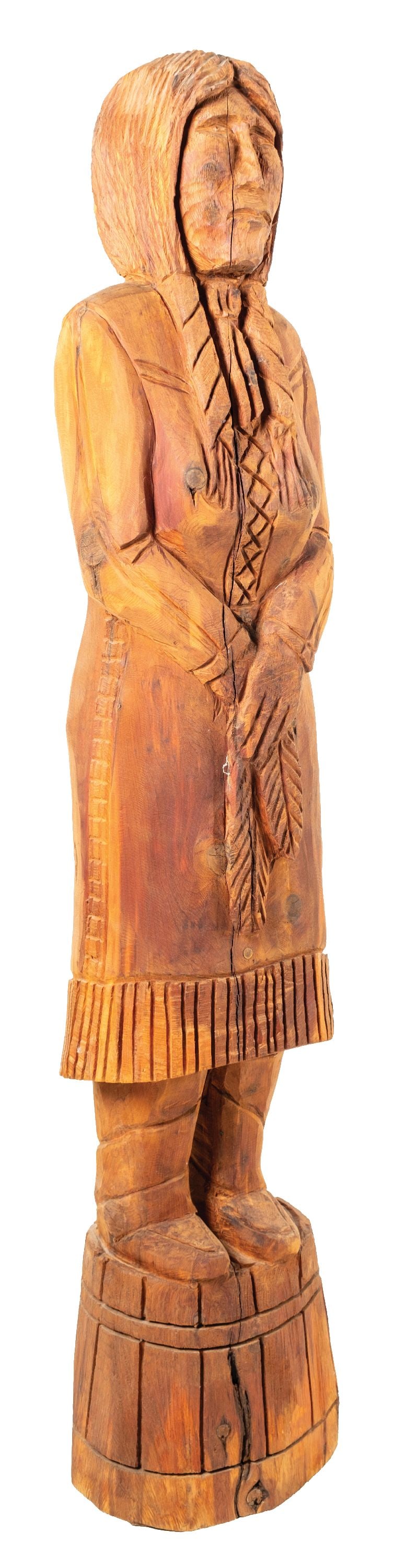 WOODEN SCULPTURE OF NATIVE AMERICAN WOMAN: A wood carving of a Native American woman holding tobacco leaves, standing on what appears to be a barrel. CONDITION: Overall very good. This is not a standard shippable item and will require 3rd part