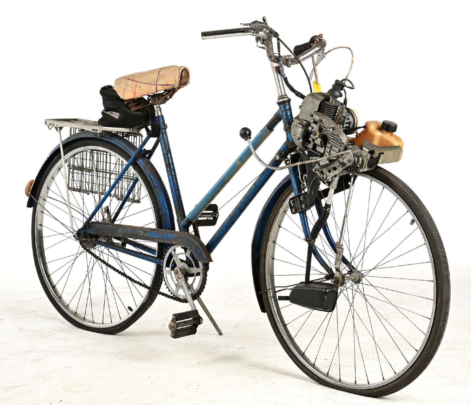 VINTAGE "DUNLET" MOTORIZED COMMUTER BICYCLE: CONDITION: Showing significant road use, with added rear baskets, replaced saddle, original handlebars, and original front mount motor. Scuffs and scrapes and areas of oxidation throughout. This is no