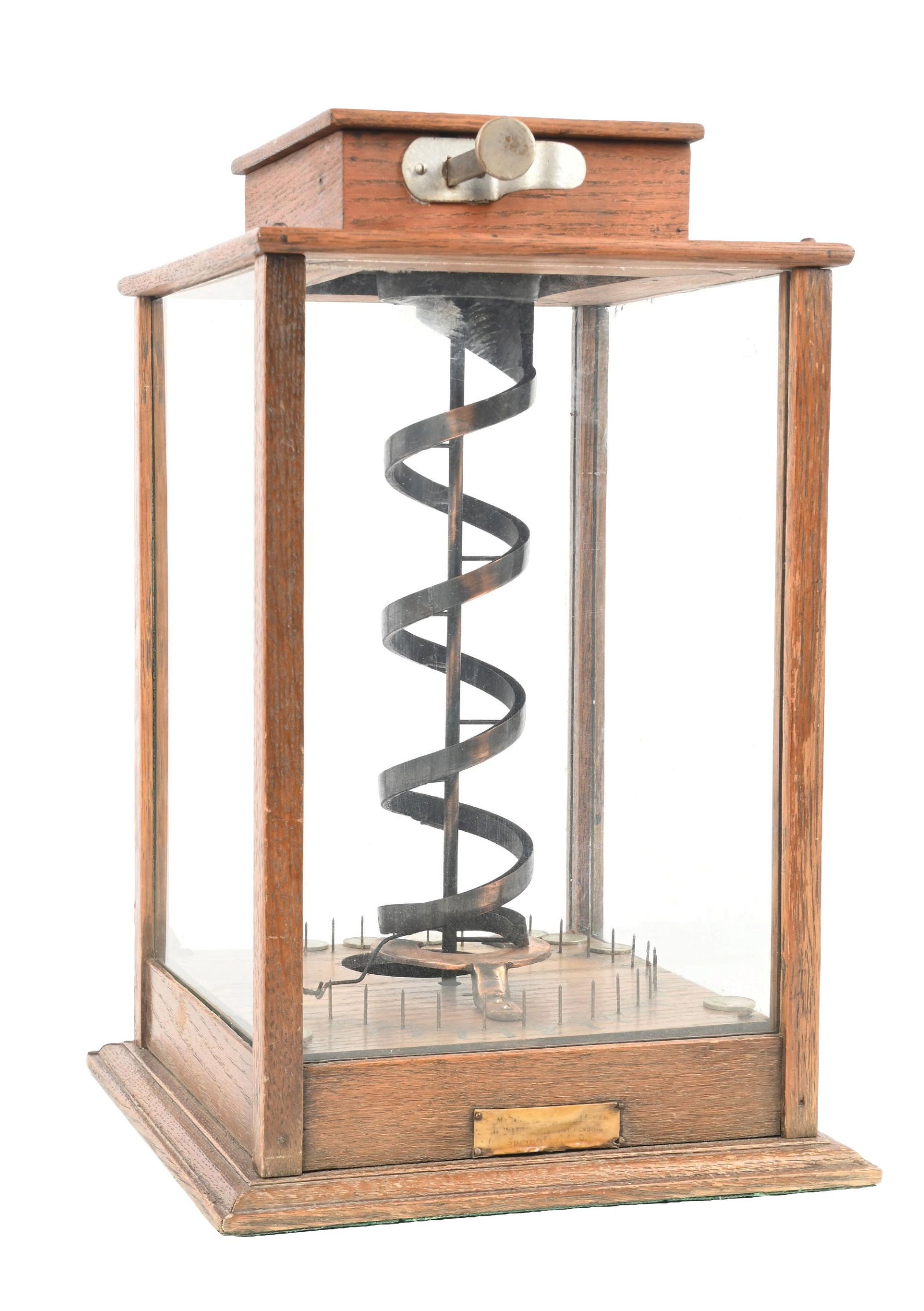 5¢ 20TH CENTURY NOVELTY CO. SPIRAL TRADE STIMULATOR: C. 1899. CONDITION: It shows an original oak case with an original finish, glass, and the majority of the original paper bottom label, correct 20th Century celluloid tag and coin door. It operates ver