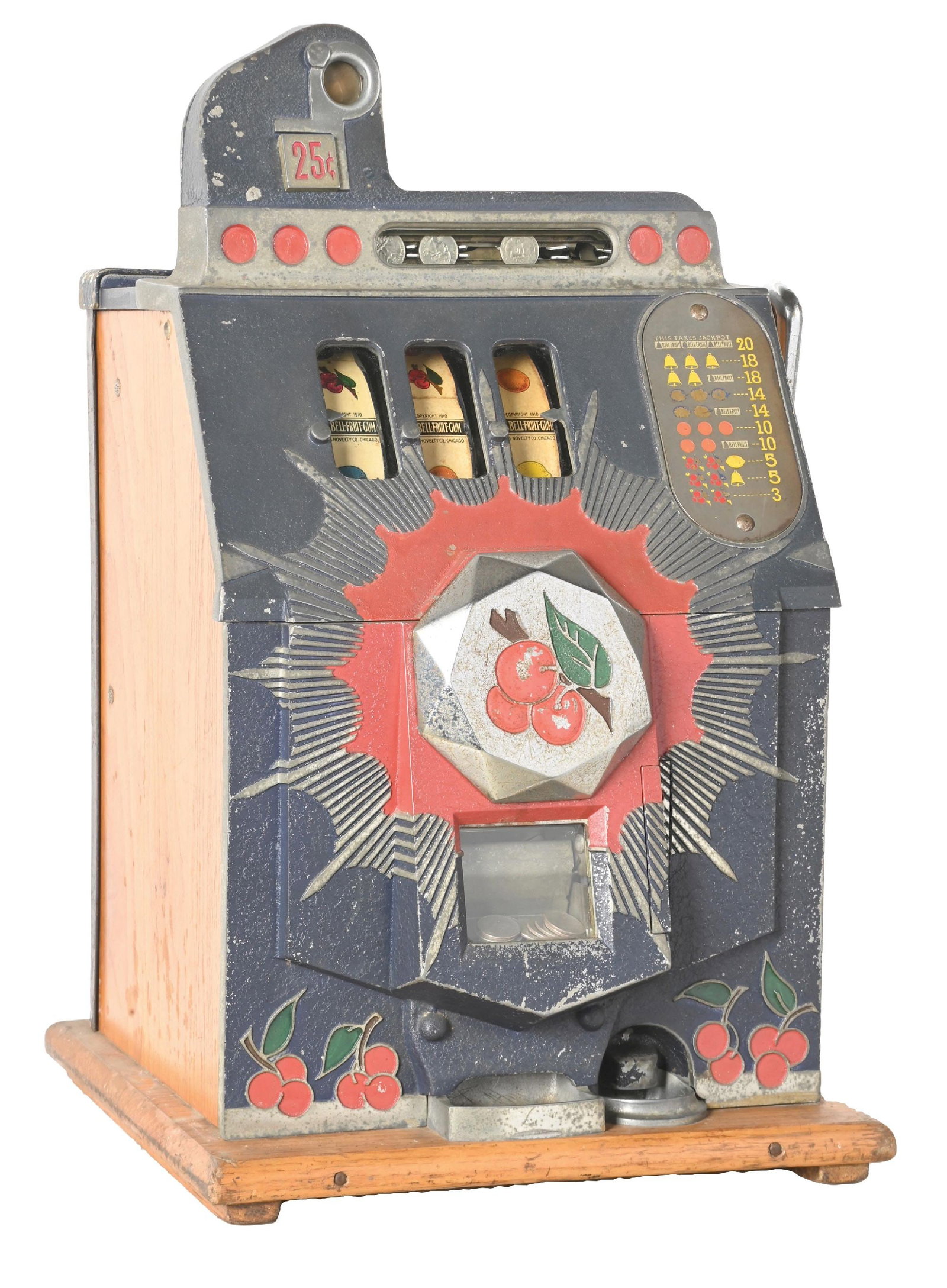 25¢ MILLS NOVELTY CO. BURSTING CHERRY SLOT MACHINE: CONDITION: Showing an unrestored machine with original reel strips, award card, back door, paint and plating. Plays well, but currently is not paying due to a dry crease issue with the coin slides. Ja
