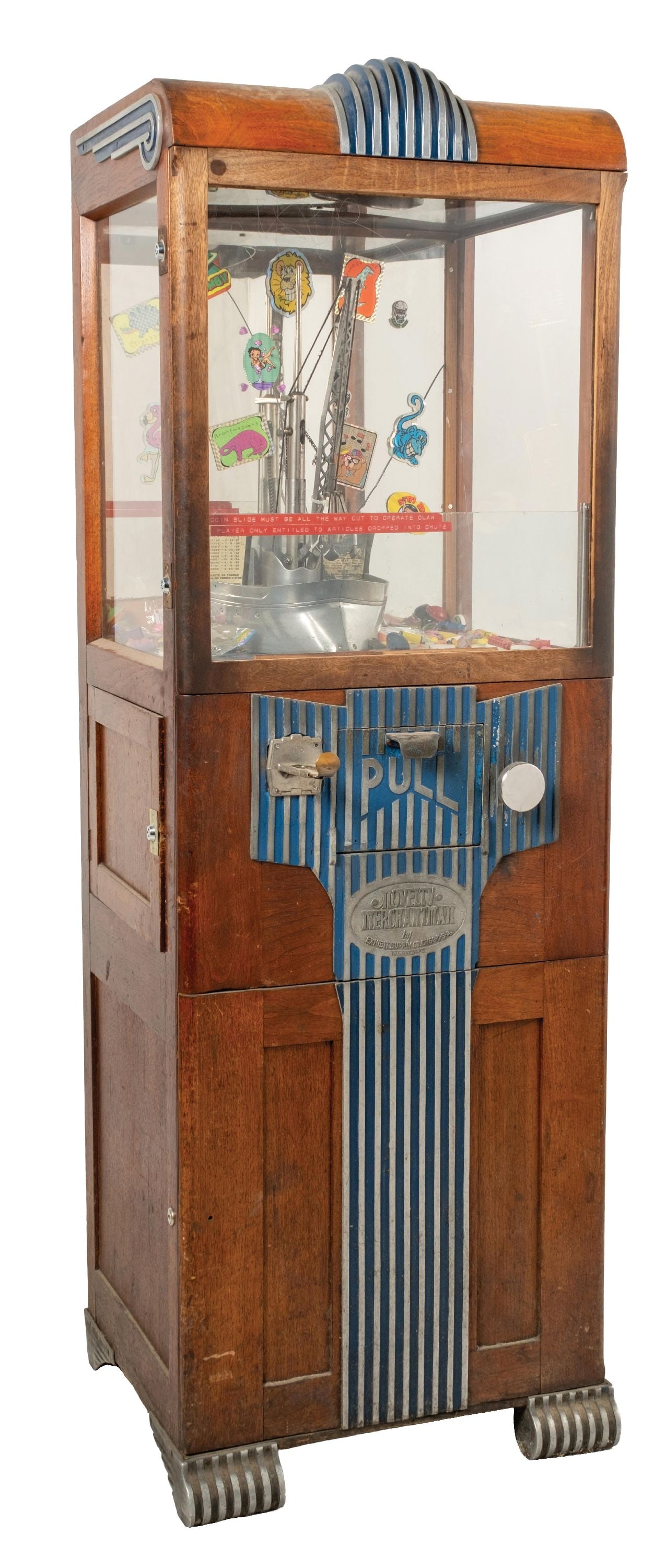 EXHIBIT SUPPLY CO. "NOVELTY MERCHANTMAN" ARCADE MACHINE: Novelty Merchant manufactured by Exhibit Supply Co., Chicago, U.S.A. Machine and castings are original. Has a great look, with Deco trim painted in the original blue colors. CONDITION: Machine is in f