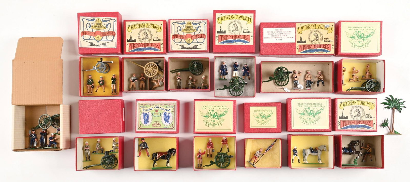 LARGE LOT OF TROPHY TOY SOLDIERS IN ORIGINAL BOXES: (A) No. EQ44 Gatling Gun with Coldstream Guard. 4 pieces. (B) KRRC Gatling Gun Set. 4 pieces. (C) Highland Flag Bearer. 1 piece. (D) Boer Cavalry. 2 pieces. (E) No. EQ37 Gatling Gun with Royal Navy Cr