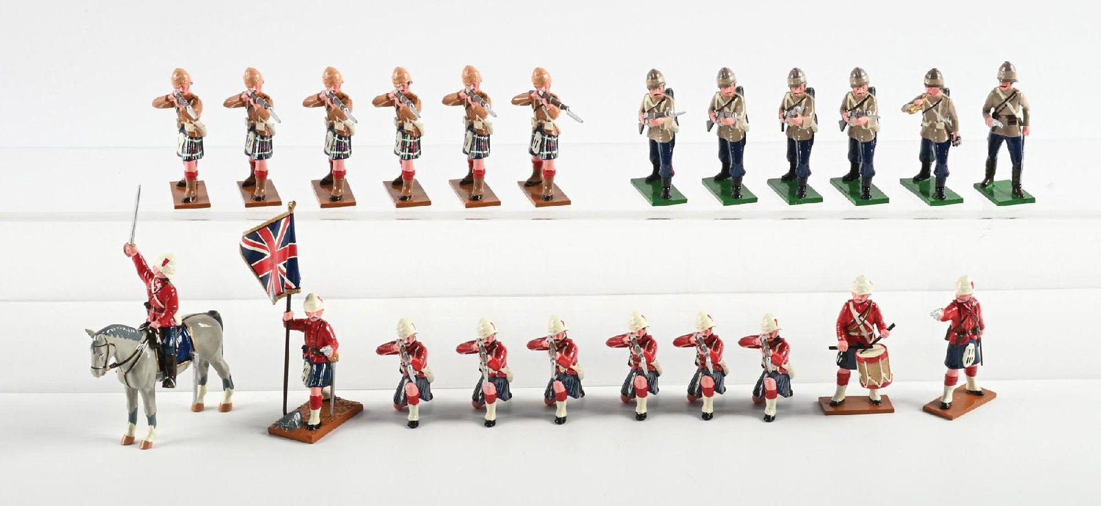 TROPHY HIGHLANDERS IN ACTION ASSORTMENT: Includes Highlanders kneeling firing, in action, buglers, 1 mounted officer, 1 standard bearer. No original box. 21 pieces. Condition: Dimensions: Box: 17" x 16 - 1/4" x 3".