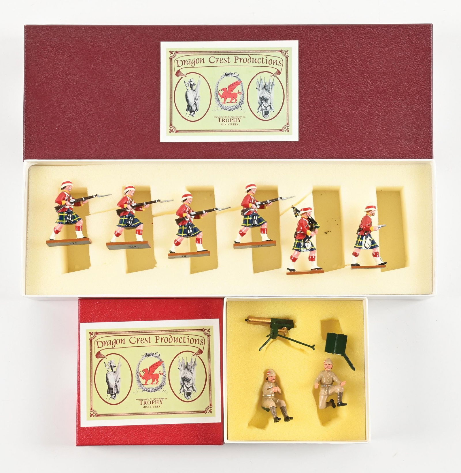 LOT OF 2: TROPHY DRAGON CREST EGYPT & SUDAN: (A) Sergeant Major, Drummer, & Privates No. DEW4. 6 pieces. (B) Machine Gun Team No. DEQ50. 4 pieces. 10 pieces total. Condition: Dimensions: Largest Box: 14" x 4 - 3/4" x 2".