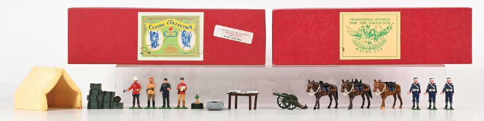 LOT OF 2: TROPHY TOY SOLDIER SETS IN ORIGINAL BOXES: (A) Zulu War Battle Strategy No. TD1A with tent, table, and cot. 9 pieces. (B) Zulu War Royal Marine Mountain Artillery with mules and dismantled cannon. 10 pieces. 19 pieces total. Condition: Dimensi