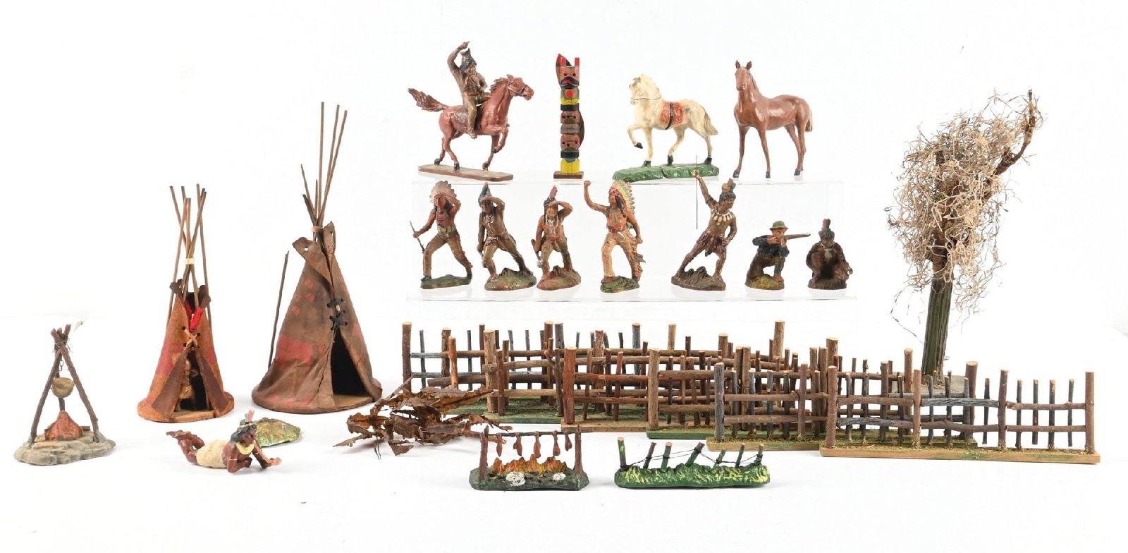 TIPPLE-TOPPLE & OHM HAUSSER INDIAN ENCAMPMENT: Lot includes 6 Hausser foot and mounted Indians, Hausser foot Cowboy, 2 Tipple-Topple Indian Chiefs, 2 German Tipis, 7 wooden fences, 1 very early tree, 2 campfires, and a Trico fence. Also includes