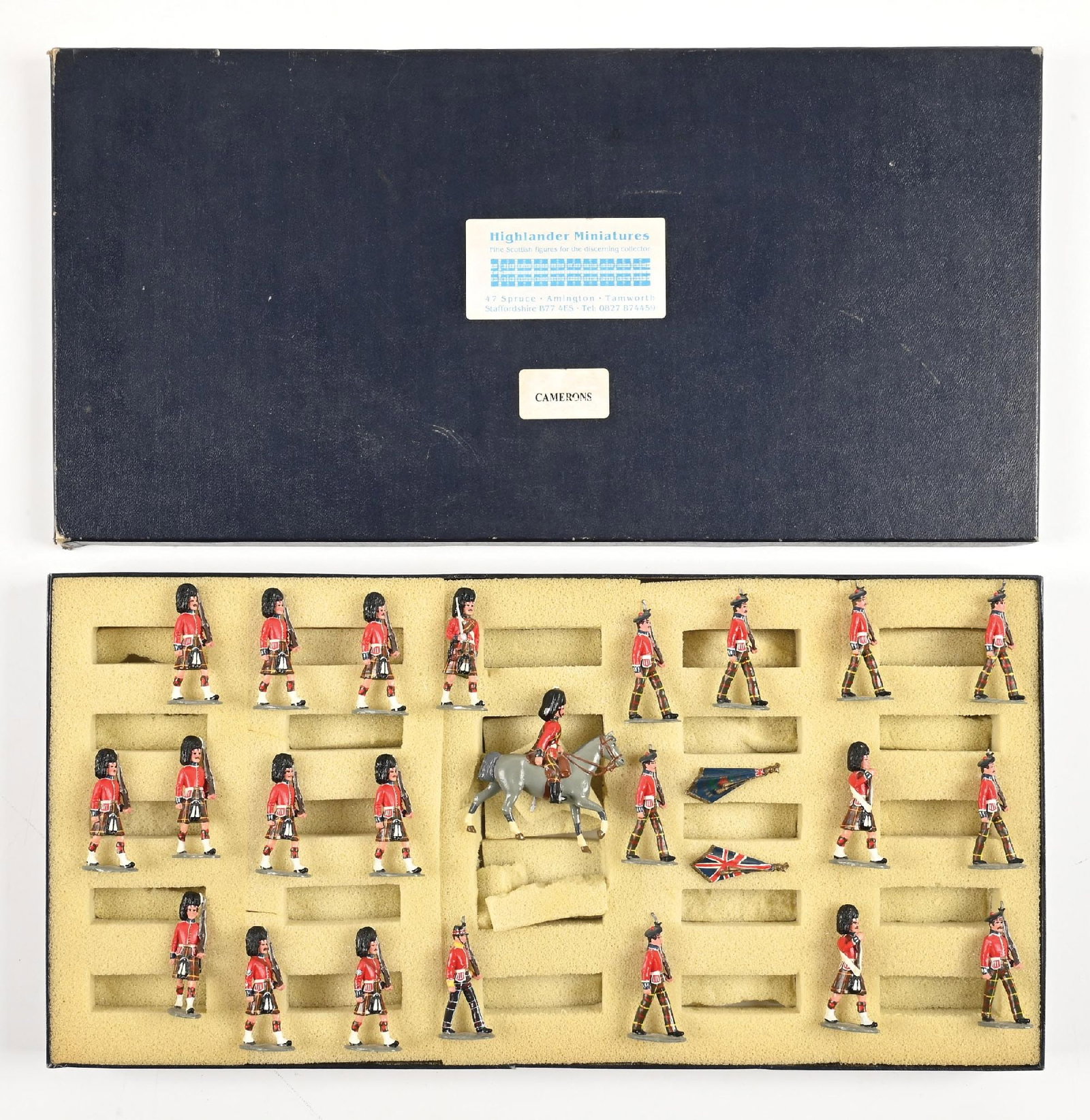 HIGHLANDER MINIATURES SET IN BOX: Marching shoulder arms, including mounted officer and colour guard. 23 pieces. Condition: Dimensions: Box: 19 - 1/2" x 9 - 3/4" x 1 - 1/2".