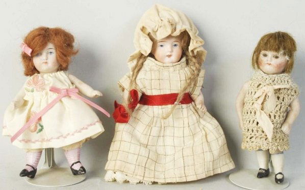Lot of 3: All Bisque Girl Dolls.: Kestner with glass eyes (splotchy cheeks) original wig; Kestner with painted eyes and pink stockings (replaced arms); SWC with painted eyes and o
