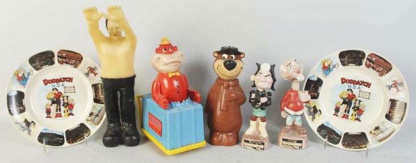 Lot of 7: Plastic & Vinyl Character Items.: Includes one wind-up Magilla Gorilla in cart, two Dogpatch nodders, two Dogpatch plastic plates, one Yogi Bear plastic bank, and one rubber Frankenstein figure. Various conditions. Condition (Very Goo