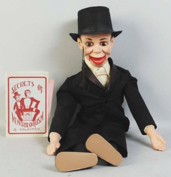 Charlie McCarthy Ventriloquist Doll.: Circa 1950s. Includes original hat, monocle, and book by Calostro. Some creasing to hat. Condition (Very Good). Size 29 - 1/2" T.