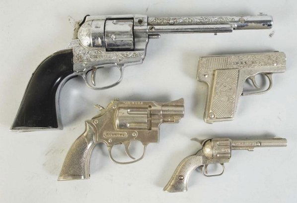 Lot of 4: Hubley Cap Guns.: Includes one revolving cylinder with broken spring, one trooper with broken spring, one marked "Dick", and one marked "Pal". Condition (Very Good). Size Largest: 13" L.