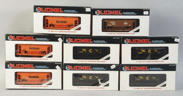 Lot of 8: Lionel Ore Train Cars.: Contemporary. Includes four Chessie, three Amtrak, and one B&LE. Includes all original boxes. Condition (Excellent).