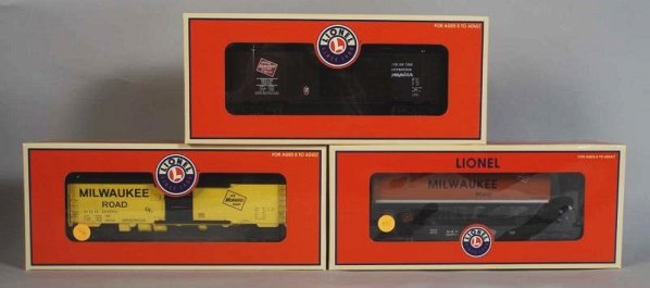 Lot of 3: Lionel Milwaukee Road Freight Cars.: Contemporary. Includes two boxcars and one flat car. Includes all original boxes with shipping box. Condition (Near Mint).