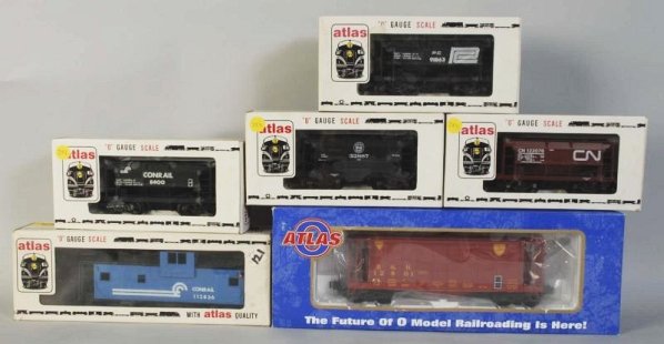 Lot of 6: Atlas Freight Train Cars.: Contemporary. Includes four ore cars, one hopper car, and one caboose. Includes all original boxes. Condition (Excellent).