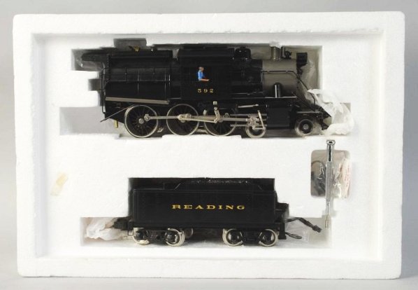 Williams Camelback Steam Engine & Tender.: Contemporary. Made in Korea. O-gauge. Brass boiler. Engine marked "592" and tender marked "Reading". Includes original box with a few pieces of masking tape. Condition (Near Mint).