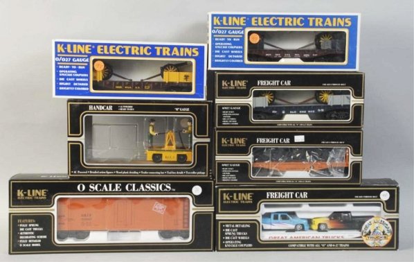 Lot of 7: K-Line Freight Train Cars.: Contemporary. Includes one motorized handcar (missing trailer) and six freight cars. Includes all original boxes. Condition (Excellent).