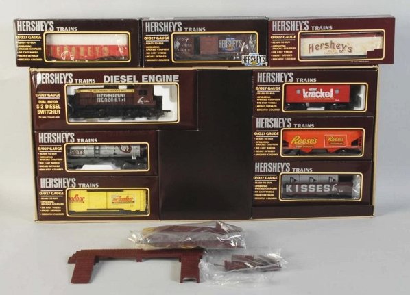 K-Line Hershey's Freight Train Set.: Contemporary. O-27 gauge. Includes a diesel switcher, seven freight cars, one caboose, and one Chocolate Town Station. All cars have advertising for Hershey's products. Includes all original boxes wit