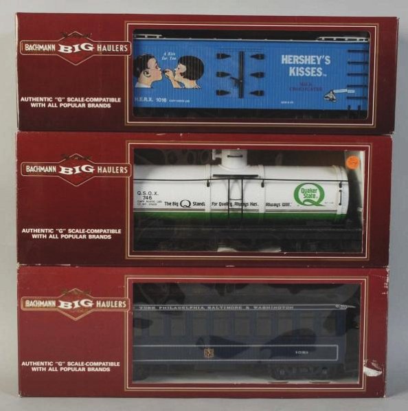 Lot of 3: Bachmann Train Cars.: Contemporary. G-gauge. Includes a Hershey Kiss boxcar, Quaker State tank car, and one passenger car. Includes all original boxes with some damage. Condition (Excellent).