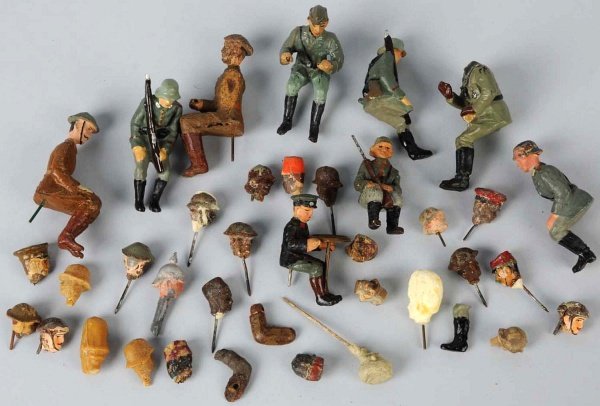 Lineol & Elastolin Seated Figures & Heads.: With nine seated figures and approximately 24 original and recent heads. One nice seated driver holding a tinplate steering wheel. Condition (Poor - Good).