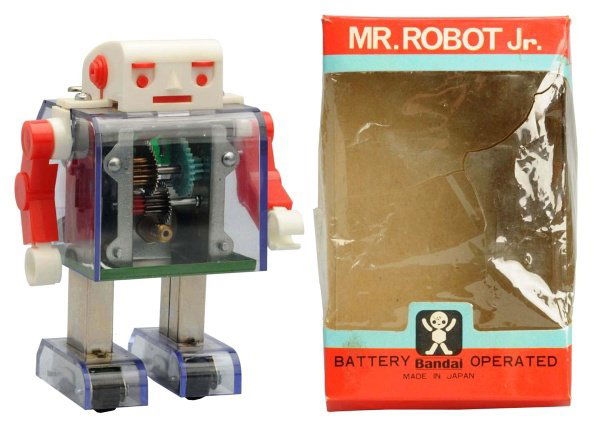 Plastic & Metal Battery-Operated Mr. Robot Jr.: Japanese, Bandai. Working. Original box included which has a tear to the cellophane window and one small tear to corner. Condition Toy (Near Mint) Box (Excellent). Size 4 - 1/2" T.