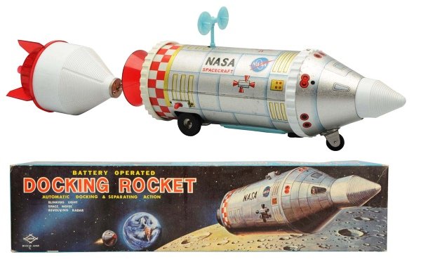 Tin Litho & Plastic Battery-Op Docking Rocket.: Japanese, Daiya. Working. Toy has some oxidation on tin. Includes original box. Toy (Excellent) Box (Excellent - Near Mint). Size 22 - 1/2" L.