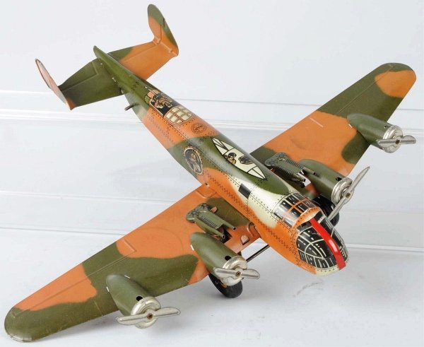 Tin Litho Marx Sparkling Aeroplane Wind-Up Toy.: American. Working. Camouflage military version with guns and props. Plane has very little wear overall. Includes original box with some staining, creasing, and flaps missing from one end. Condition To
