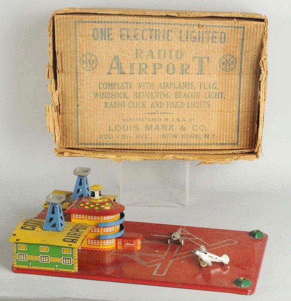 Pressed Steel Marx Radio Airport Toy.: American. Comes with three diecast airplanes (one plane missing prop). Needs to light bulbs and beacon radar piece. Includes original box. Condition (Very Good). Size Box: 17" x 11 - 1/2".