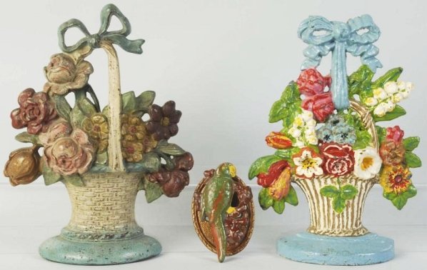 Lot of 3: Cast Iron Doorstops & Doorknocker.: Flower doorstops by Hubley: Lilies of the Valley is repainted. Parrot doorknocker is a reproduction. Condition (Good - Very Good). Size Largest: 10 - 3/4" T.