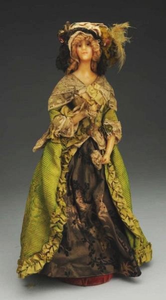 French Wax Fashion Doll.: Display lady with wax shoulder head, yarn wig; hard torso and cloth wrapped legs with shoes and stockings, wax lower arms. All original in fancy silk and lace historical period costume with hat and wi