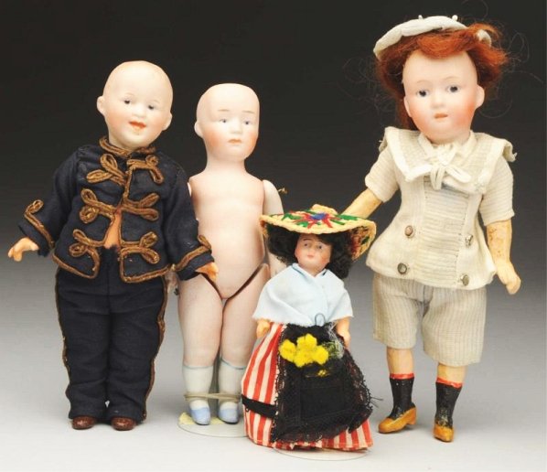 Lot of 4: Small Antique Dolls.: Gebr. Heubach boy fully incised with 8778 and square mark, painted features with intaglio eyes, mohair wig, five-piece composition body with molded shoes and socks, factory original suit and hat; anot